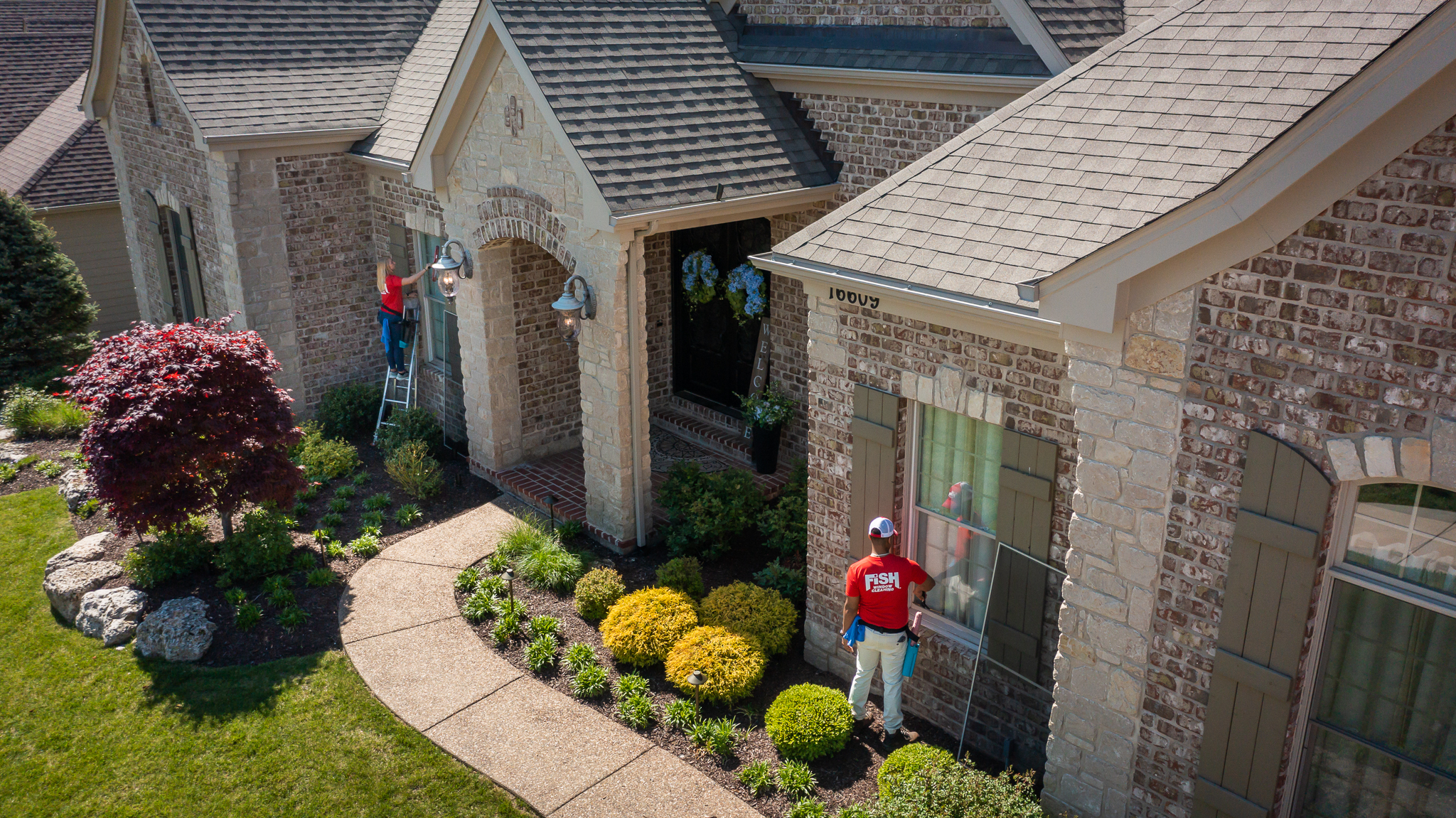 Aerial View of Home with Two FISH Window Cleaners Cleaning Windows